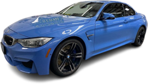 A blue BMW sports car is parked indoors, viewed from the front left side.